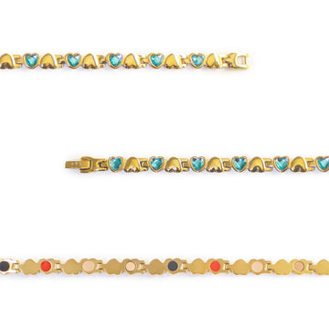Close-up of Celeste bracelet showing gold-plated settings with blue crystal heart links.